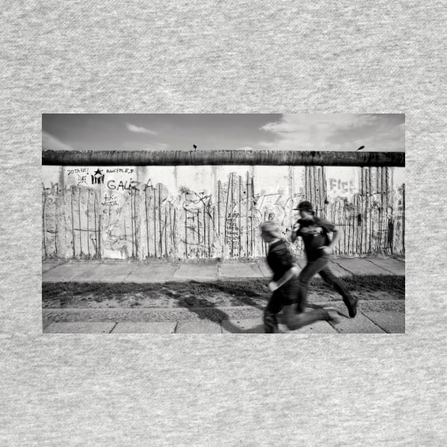 Two kids running along the remains of the Berlin Wall, Berlin, Germany by Reinvention